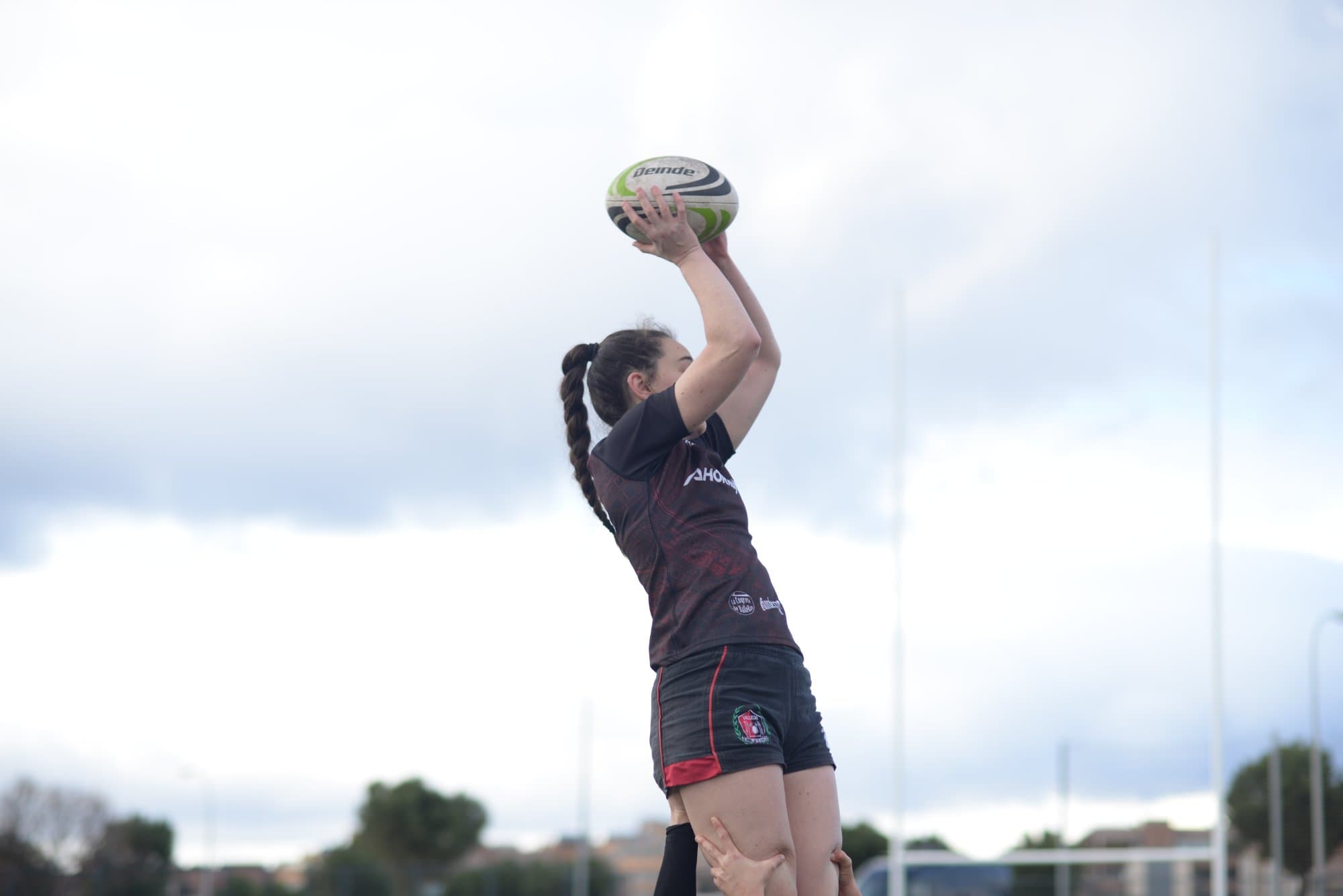 Jugadora de Vallecas Rugby Unión recibe el balón durante una sesión en el campo de rugby